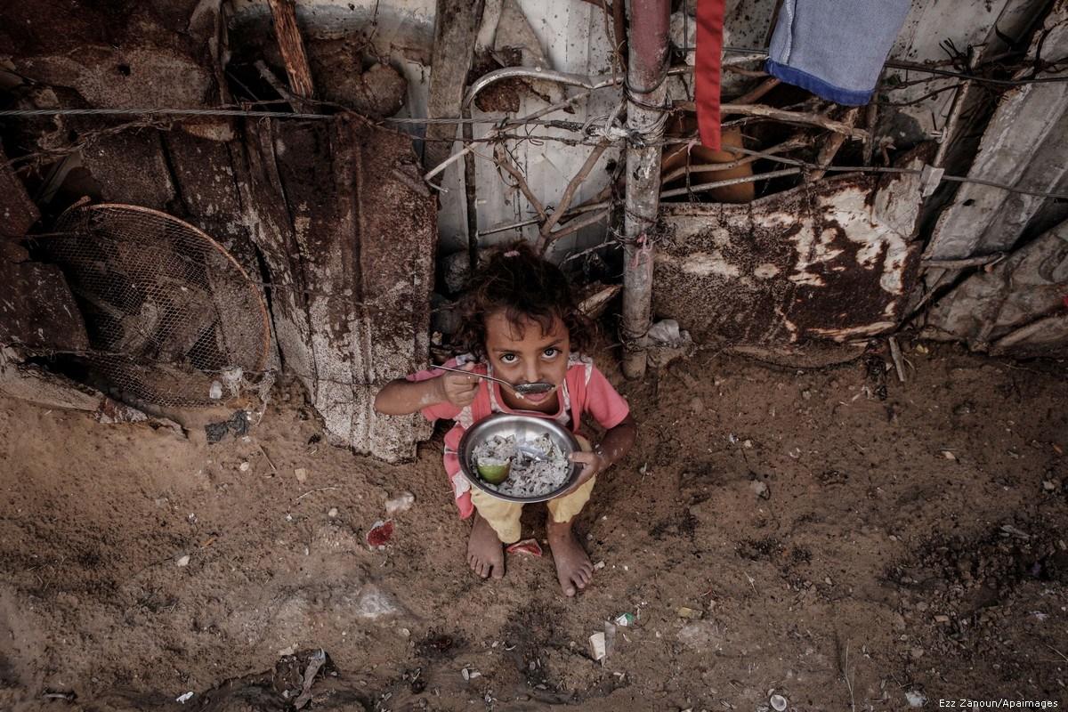 A Palestinian child can be seen outside her home in the poverty-stricken quarter of Al-Zaytoon in Gaza City on 29 September 2014 [Ezz Zanoun/Apaimages]